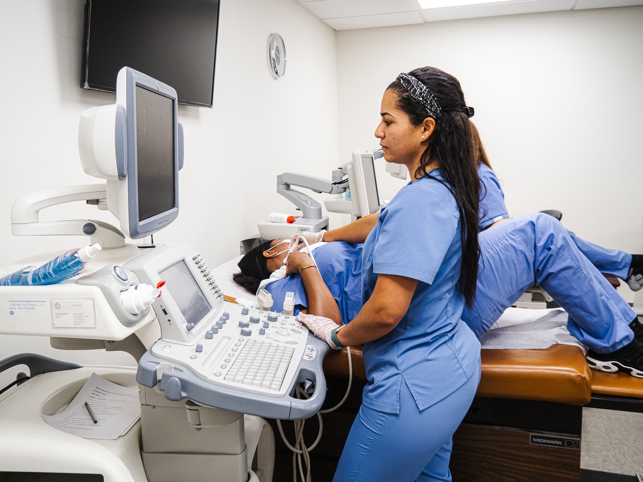 Ultrasound instructor guiding a student during training