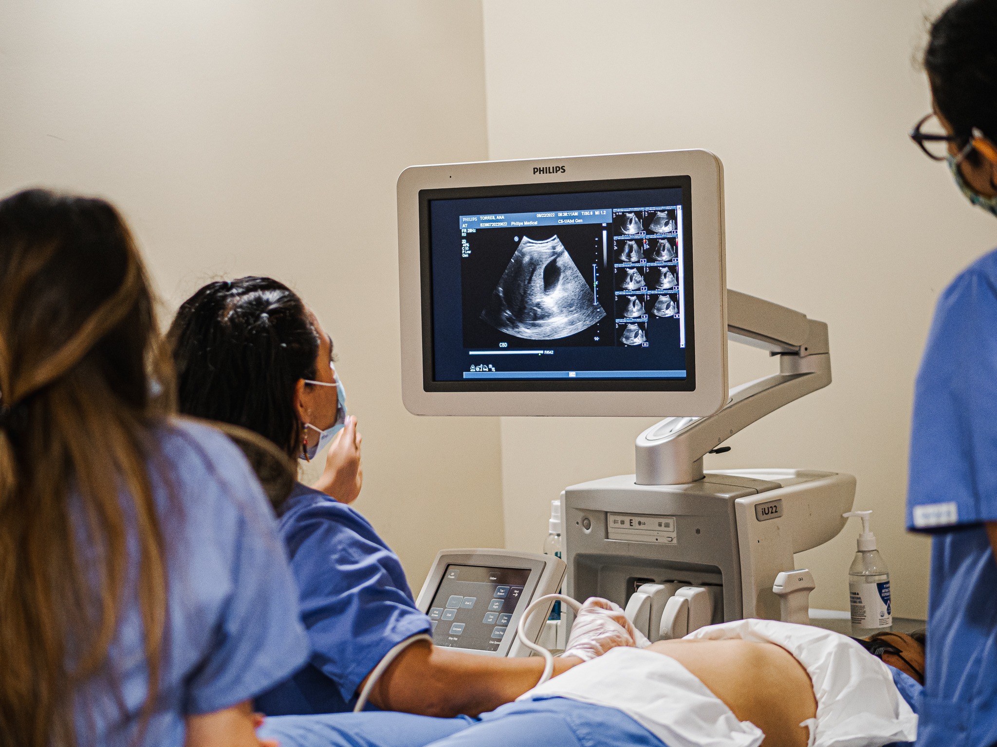 Students practicing ultrasound scanning in a lab setting